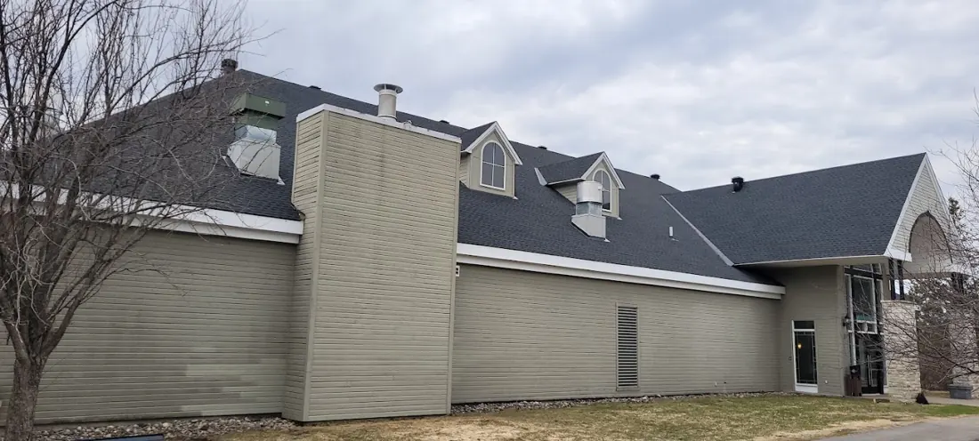Roof deck covered in black underlayment with a blue-printed membrane at the top