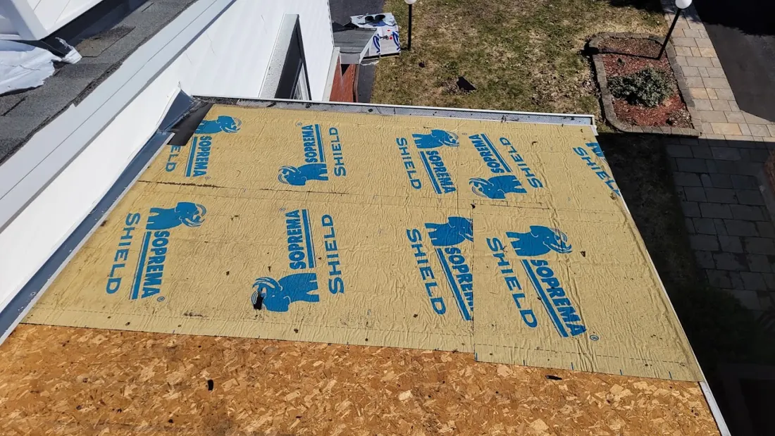 Plywood roof deck covered with blue-printed underlayment